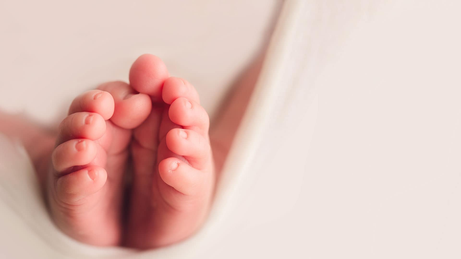 A close-up of a baby’s tiny feet.